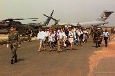Image: Evacuees from Liberia are led away from a U.S. Air Force MH-53 Pavelow.