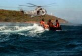 Thumbnail: Explosive Ordnance Disposal technician jumps from a SH-3H Sea King helicopter.
