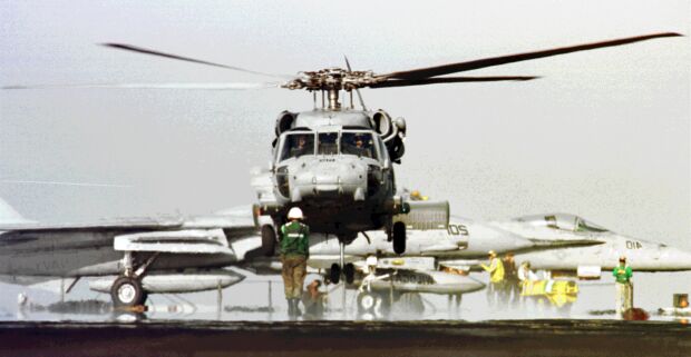 Image: An SH-60F Seahawk helicopter lands on the deck of USS John C. Stennis