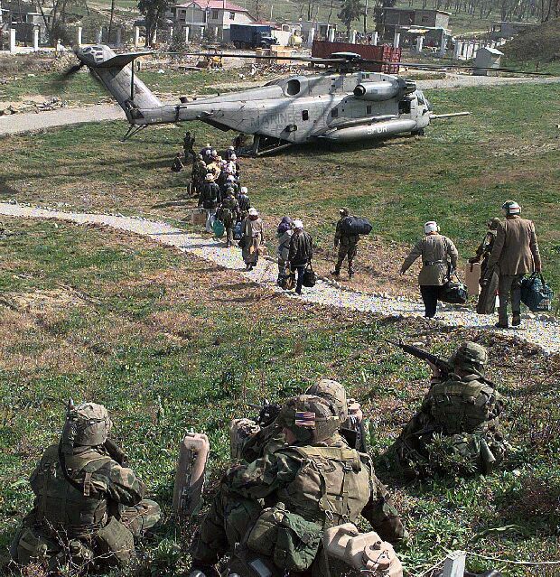 Image: American evacuees walk to a U.S. Marine Corps CH-53 helicopter in Tirana, Albania.