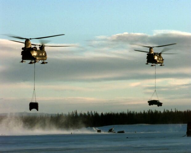 Image: Two U.S. Army CH-47 Chinook helicopters sling load Humvees during Northern Edge 98.